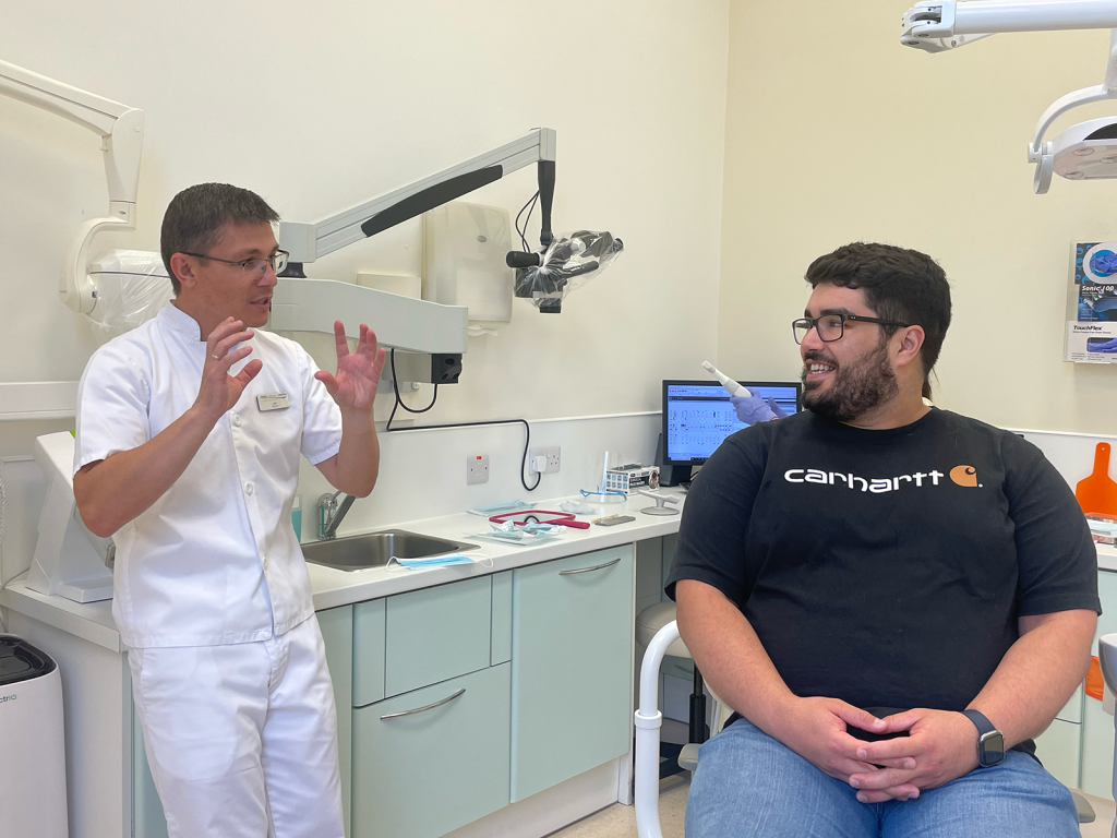 Dentist consulting with patient , discussing composite bonding treatment.